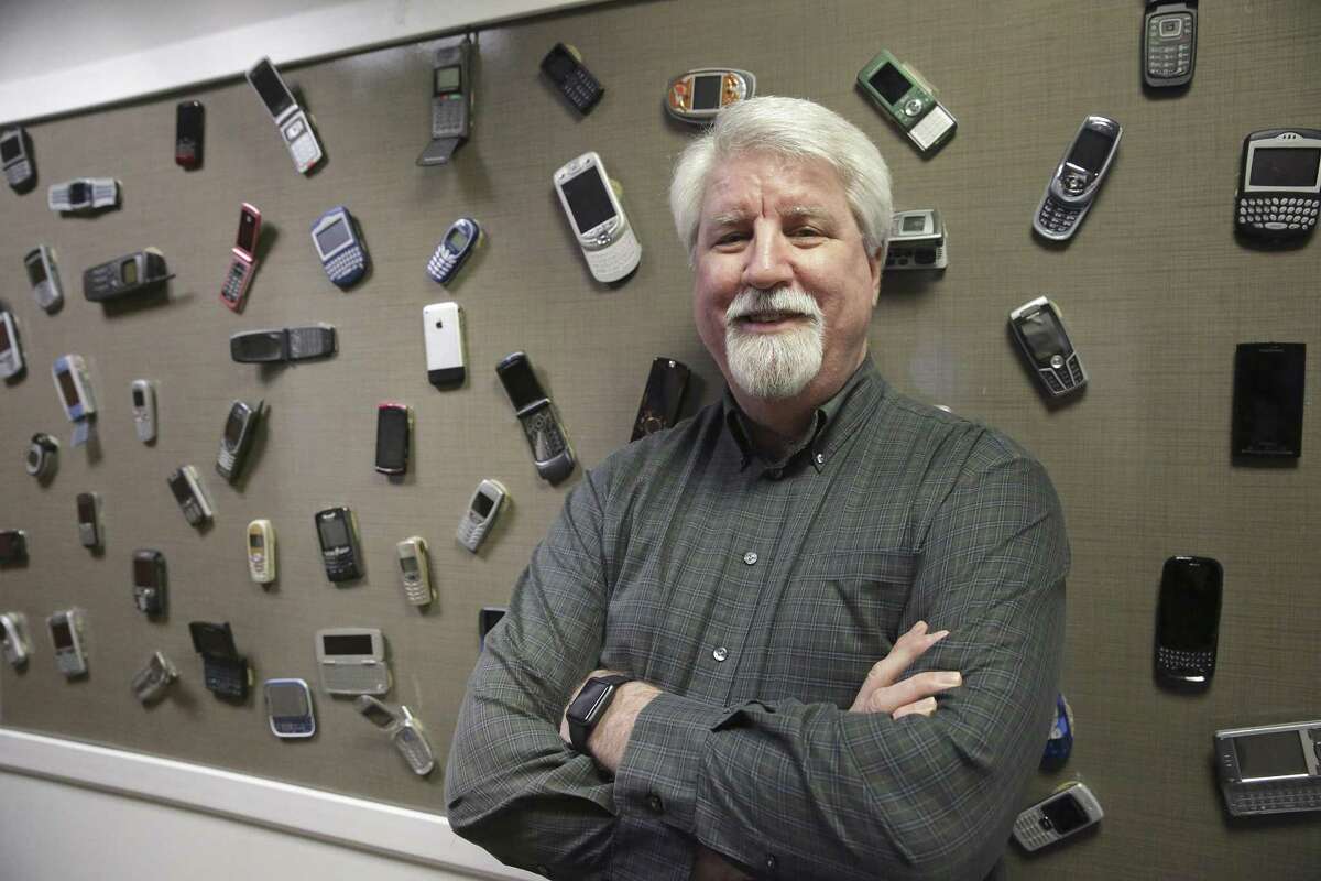 Dave Wolter, assistant vice president of radio technology and strategy at AT&T, in front of a display board of old phones at AT&T's Austin 5G lab on February 16, 2018. Its predecessor, 4G technology, was aimed at mobile phones while 5G technology provides super fast connectivity for larger and more complex devices, including self-driving cars.
