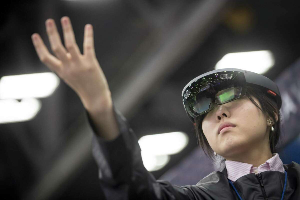 An attendee wears a Microsoft Corp. HoloLens headset at the South By Southwest (SXSW) conference in Austin, Texas, U.S., on Tuesday, March 13, 2018. Amid the raucous parties and speed networking at the annual festival that draws people from technology, film, and music to Austin, Texas, there will be some soul searching about gender discrimination, sexual harassment and how to fix the broken workplace culture. Photographer: David Paul Morris/Bloomberg