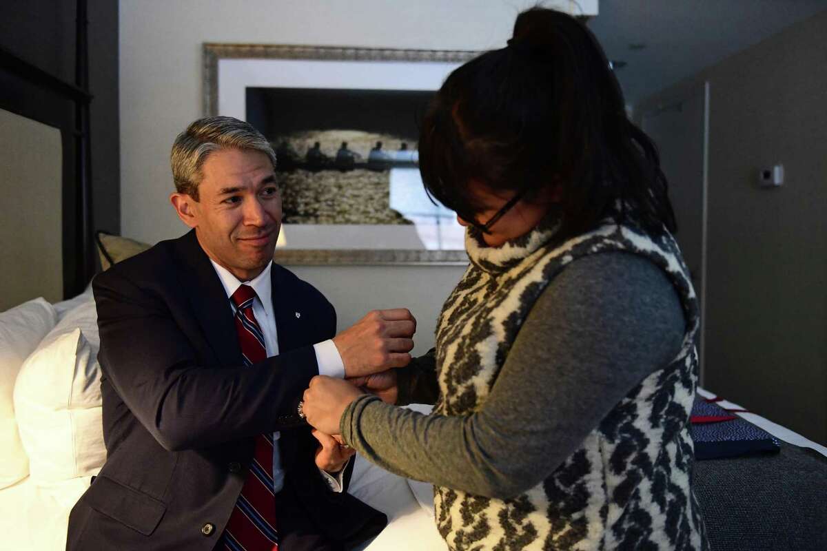 Erika Prosper helps put on cufflinks bearing the Penn shield she surprised for her husband, Ron Nirenberg, as he looks on in admiration, in their hotel room Monday, March 12, 2018 in Philadelphia, Pa. The San Antonio Mayor presented the 2018 George Gerbner Lecture in Communication “Be a Better Neighbor: The Education of a Mayor,” at the Annenberg School for Communication at the University of Pennsylvania as well as coming to visit his old collegiate stomping grounds with his family. Meeting his wife there, and his first time back with his son, Ron attributes his experience at Penn as part of shaping the person and political leader he has become. (Corey Perrine/For the San Antonio Express-News)