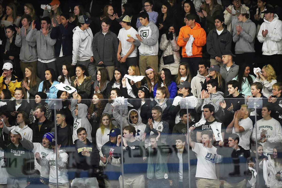 The Guilford student section cheers on the Indians against Farmington Valley in the CIAC Division II state Ice Hockey Championship, March 16, 2018, at Ingalls Rink in New Haven. Farmington Valley leads, 7-1.