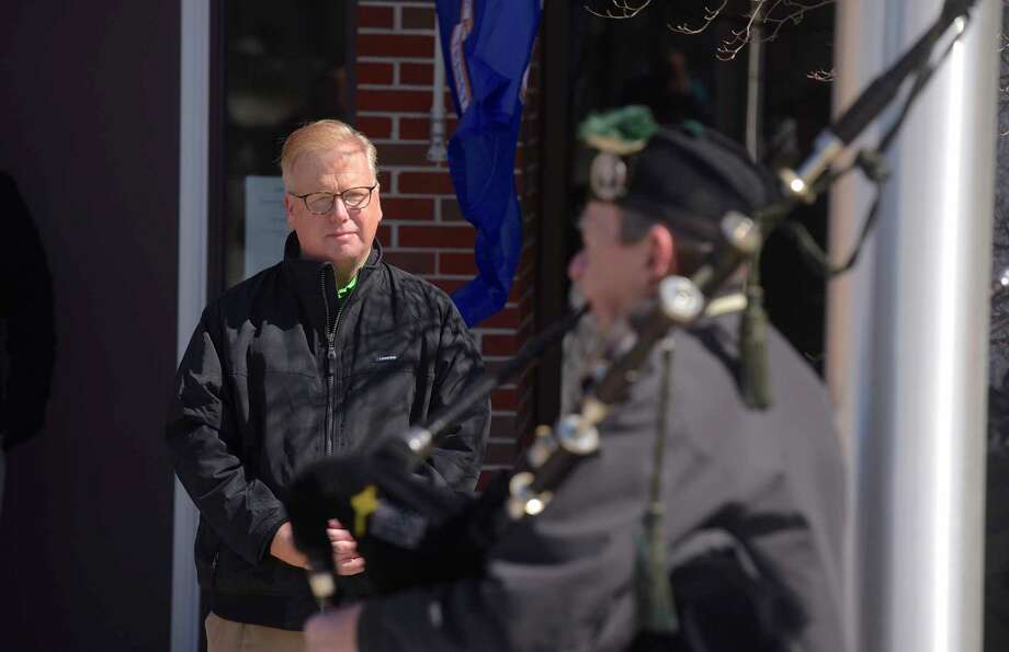 Mayor Mark Boughton watches as Peter Hearty from the Celtic Cross Pipe & Drum of Danbury, plays the bag pipes during the raising of the Irish flag at Danbury City Hall on Saturday afternoon, March 17, 2018, in Danbury, Conn. Photo: H John Voorhees III, Hearst Connecticut Media / The News-Times