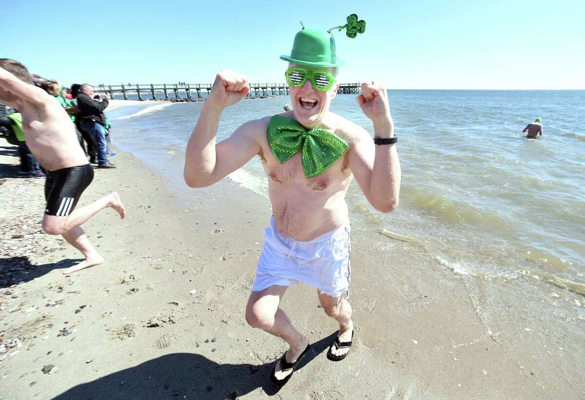 Eric Twombly of Milford emerges from the Long Island Sound during the Leprechaun Leap at Walnut Beach in Milford on March 17, 2018. The event raised money for the Literacy Volunteers of Southern Connecticut.