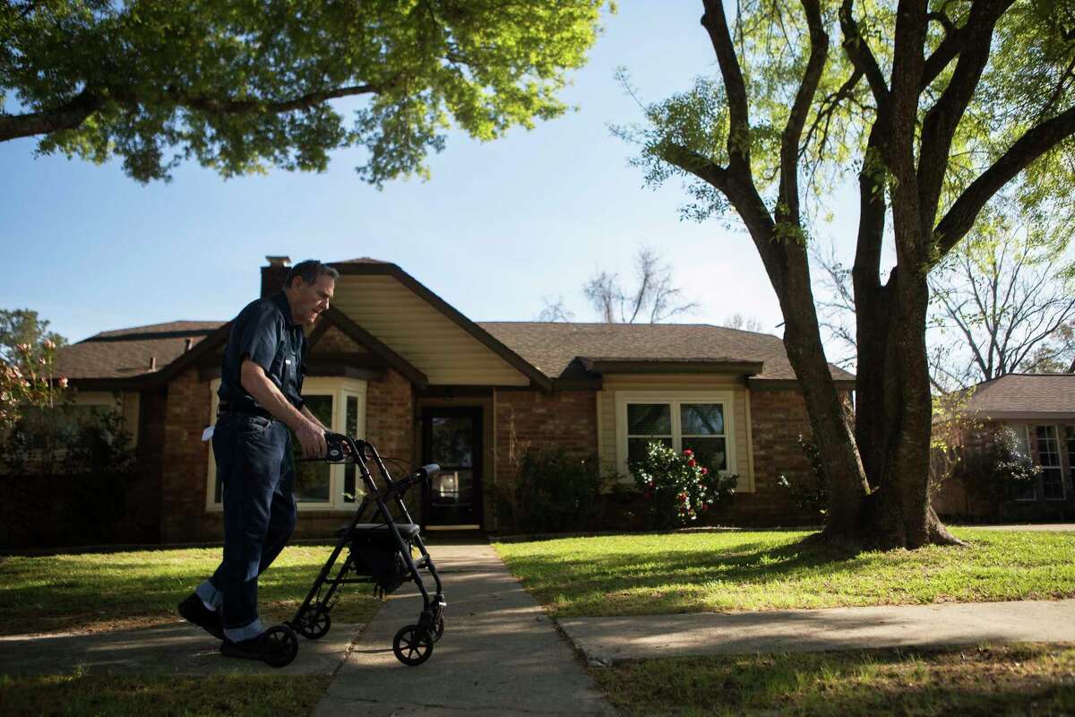 Gail Bullock, 77, takes his therapeutic walk by his home trying to recuperate from surgery. Bullock's home which is located upstream of Addicks Reservoir took on two feet of water after Hurricane Harvey struck the area. Monday, March 12, 2018.
