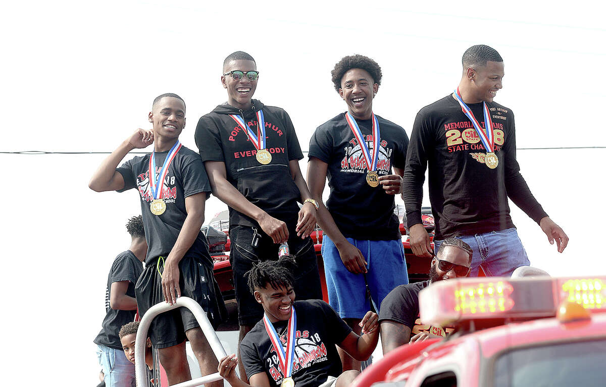 A large crowd celebrates as a parade honoring the Port Arthur Memorial basketball team's 5A state championship makes its way down Twin City Highway to Memorial Stadium Saturday. Photo taken Saturday, March 17, 2018 Kim Brent/The Enterprise