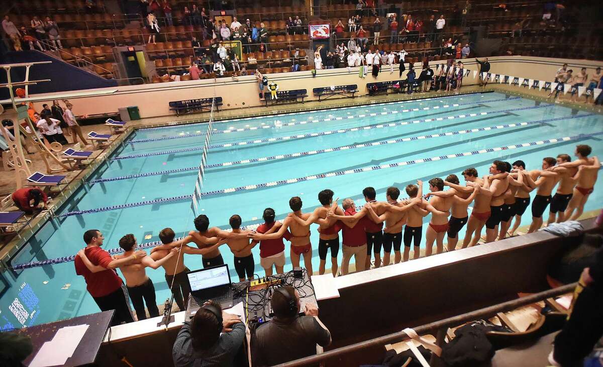 Greenwich swimmers and coaches get ready to jump in the pool to celebrate their win at the CIAC state open boys swimming championship, March 17, 2018, at Kiputh Pool at Yale University in New Haven. Greenwich won with a total of 487.5 points, finishing second, Fairfield Prep with 457 points.