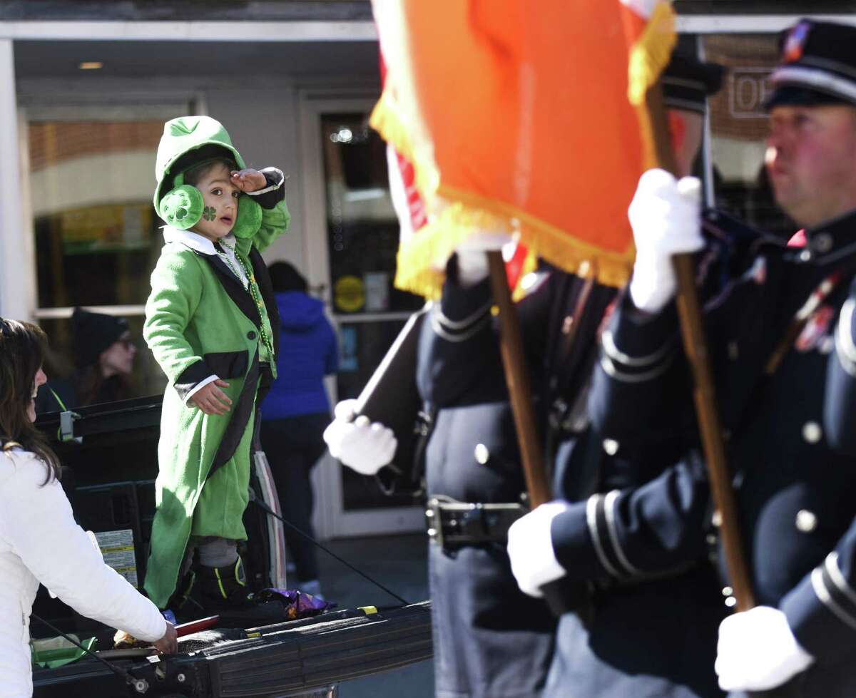 Michael Young, of Trumbull, salutes as Greenwich Police lead the Greenwich St. Patrick's Day Parade down Greenwich Avenue in Greenwich, Conn. Sunday, March 18, 2018. Presented by the Greenwich Hibernian Association, the parade featured Irish bagpipe music, Irish dancers, floats from many local organizations, as well as Greenwich police, fire and EMS.
