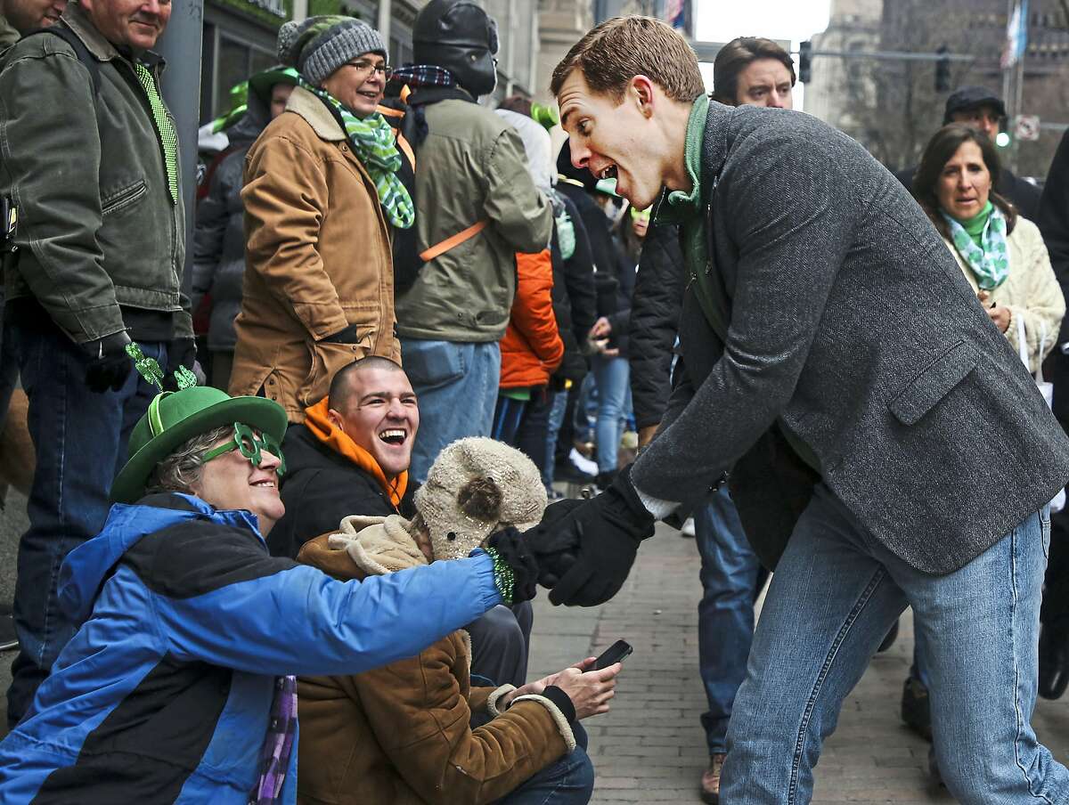 Pam Amicarella, of Jefferson Hills, shakes hands with Democrat Conor Lamb during the Pittsburgh St. Patrick's Day Parade, Saturday, March, 17, 2018, in downtown Pittsburgh. Living in the 18th Congressional District, Amicarella voted for Lamb in the March 13 special election. (Jessie Wardarski/Pittsburgh Post-Gazette via AP)