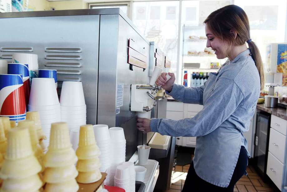 Kaitlyn Plowman prepares ice cream for customers during opening day at the Kurver Kreme on Monday, March 19, 2018, in Colonie, N.Y. This is Plowman's 5th season working at the stand. This is the 66th year of operation for the ice cream stand. The stand will be open Monday through Friday from 11:00am to 9:00pm, Saturday Noon to 9:00pm and Sunday 1:00pm to 9:00pm. Kurver also has for the second year, Dole vegan frozen treat.  (Paul Buckowski/Times Union) Photo: PAUL BUCKOWSKI, Albany Times Union / (Paul Buckowski/Times Union)
