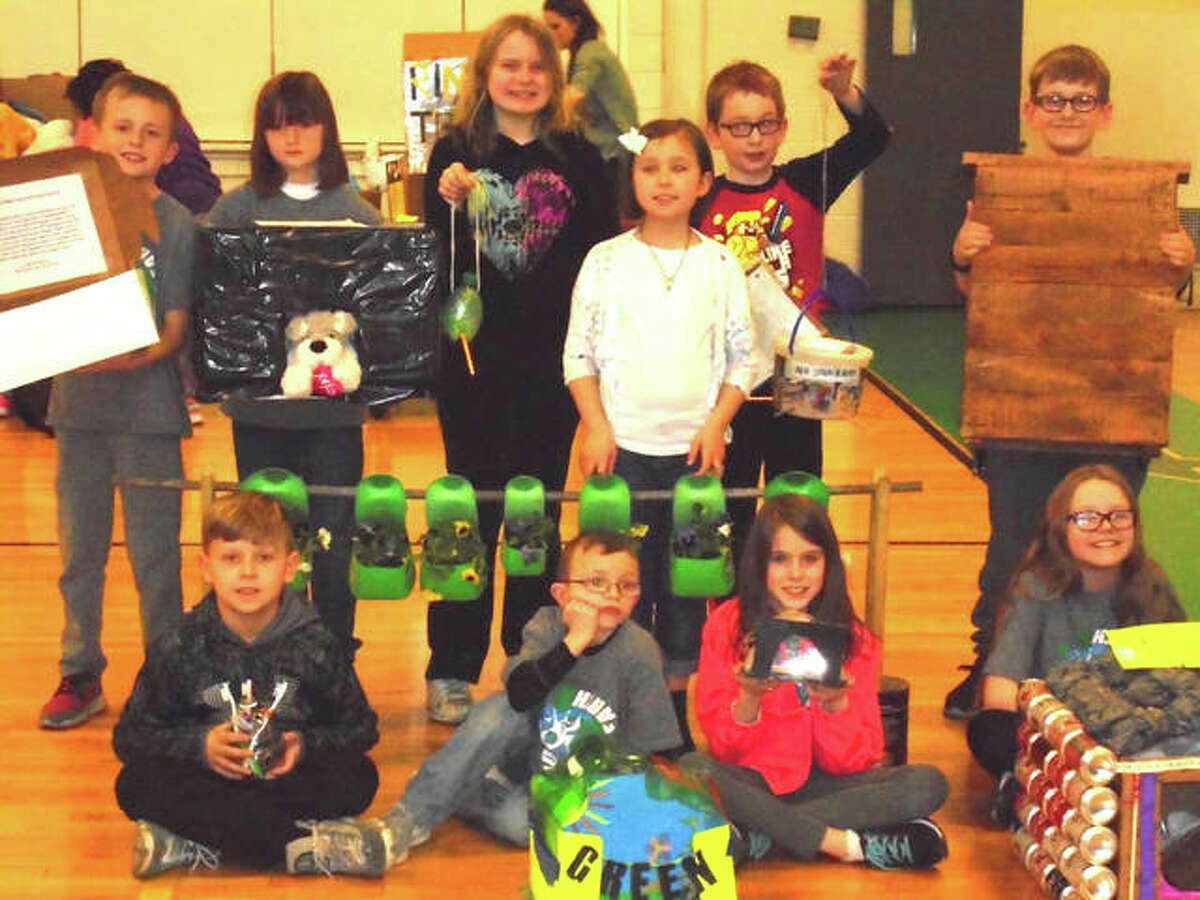 Students from North Elementary School’s “Green Team” stand with their projects made out of recycled materials.