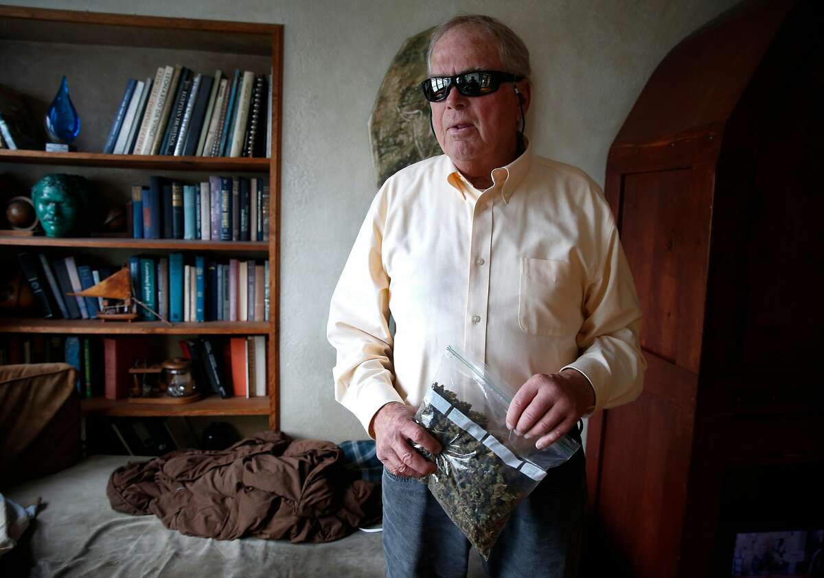 Ed Gallagher holds a baggie of medicinal cannabis at his Twin Peaks home in San Francisco, Calif. on Tuesday, March 13, 2018. After becoming totally blind a couple of decades ago and experiencing other ailments, Gallagher has relied on donated medicinal marijuana through a compassionate care act to control pain and nausea but a loophole in the recently enacted Prop. 64 has eliminated the distribution of free medical pot.
