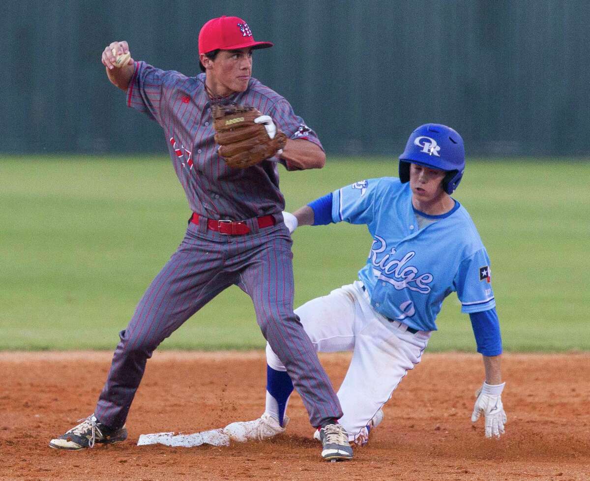 The Woodlands second baseman Ryan Solberg (33) tags out Oak Ridge center fielder Austin Brown (9) on a fielder's choice during the first inning of a District 12-6A high school baseball game at Oak Ridge High School, Friday, March 16, 2018, in Shenandoah.