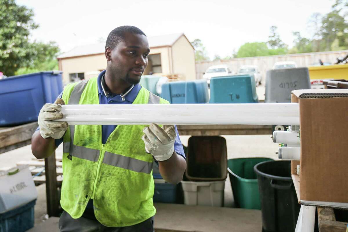 Precinct 3 foreman Raymel Stevenson slides light bulbs into a box for recycling on Monday, March 19, 2018, at the Precinct 3 Residential Recycling Center in The Woodlands.