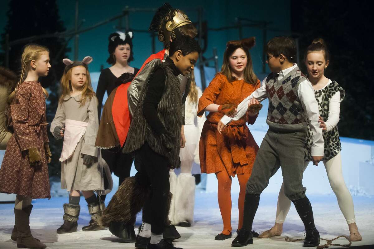 The cast of Peanut Gallery's production of "The Lion, the Witch, and the Wardrobe" act out a scene during a dress rehearsal on Monday, March 19, 2018 at the Midland Center for the Arts. (Katy Kildee/kkildee@mdn.net)