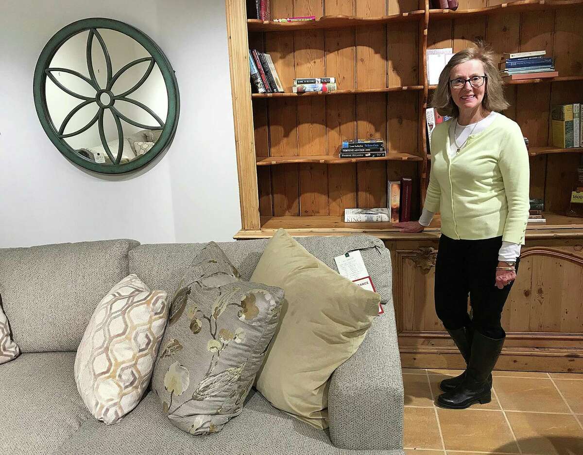 LJ Edwards Furniture and Design Studio employee Leslie Haber stands in one of the showcase rooms at the furniture store in Brookfield, Conn., on Tuesday, March 20, 2018. The store is closing on March 31.