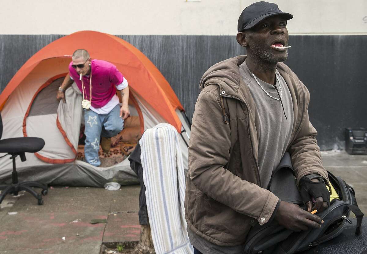 TJ calls toward a friend while standing at a homeless encampment near the corner of Florida and Treat streets Tuesday, March 20, 2018 in San Francisco, Calif.