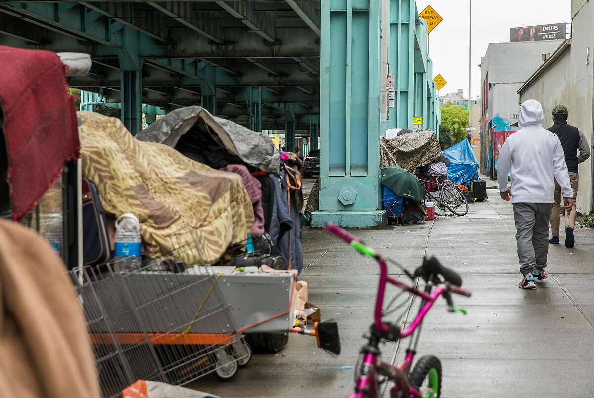 Multiple tents make up a small homeless encampment along 13th Street near Harrison Street Tuesday, March 20, 2018 in San Francisco. California's homelessness crisis requires aggressive action on lots of issues.