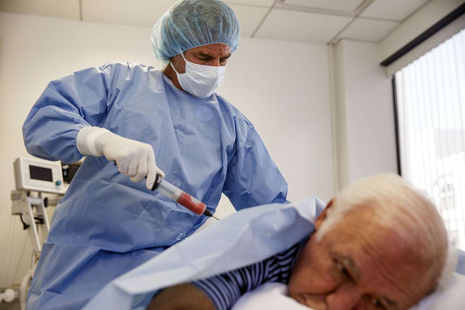 Mark Berman collects fat from a patient.