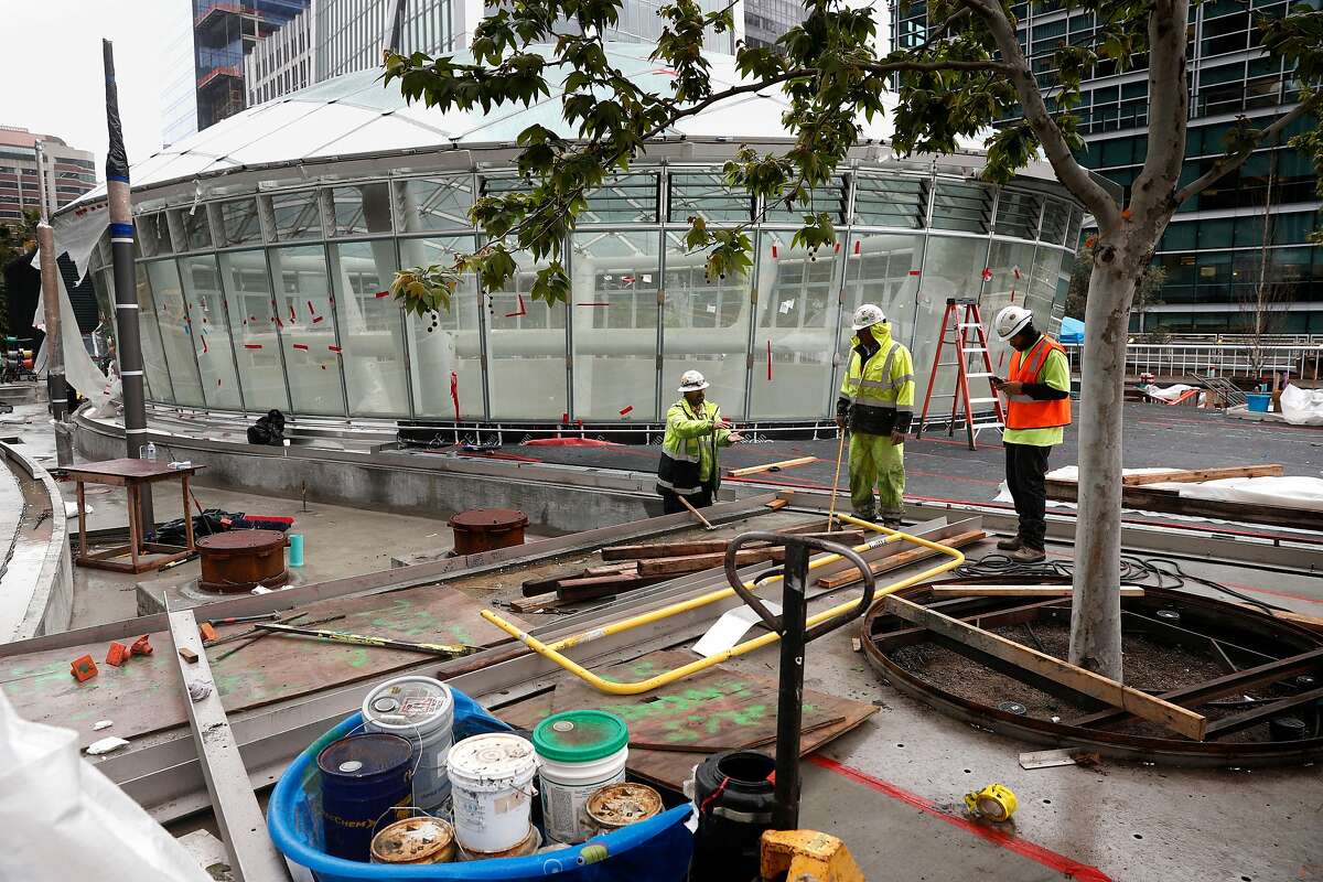 Workers on the terrace level with the oculus skylight above the grand hall is seen as construction continues on the Transbay Transit, Center in downtown San Francisco, Calif., as seen on Tues. March 20, 2018. A big grand opening of the $2.2 billion project is already being planned for sometime in June.