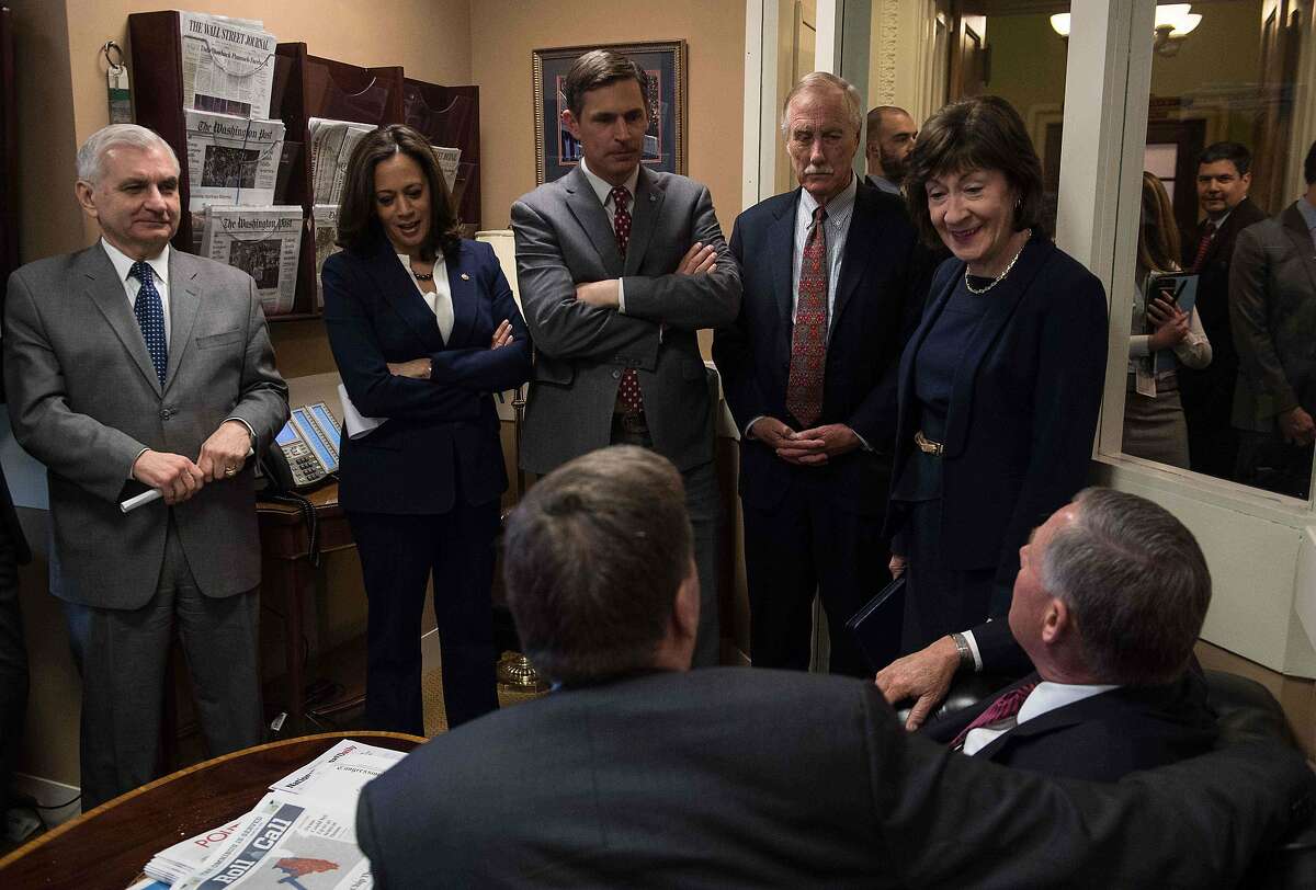 Members of the US Senate Intelligence Committee, (left to right) Jack Reed, Kamala Harris, Martin Heinrich, Angus King and Susan Collins speak with committee chairman Richard Burr (seated on right) and vice-chairman Mark Warner before a press conference on election security at the Capitol.