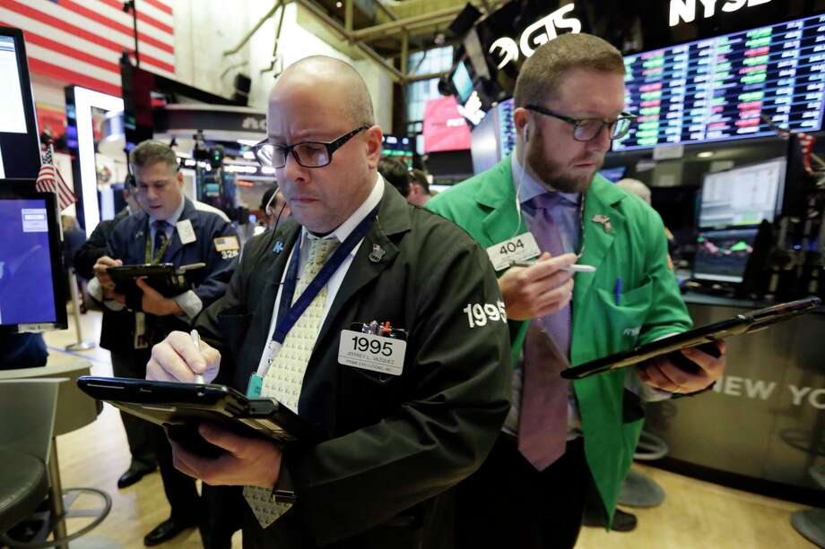 Traders Jeffrey Vazquez, center, and Ryan Falvey, right, work on the floor of the New York Stock Exchange, Tuesday, March 20, 2018. Banks and energy stocks are leading early gains for U.S. indexes. (AP Photo/Richard Drew) Photo: Richard Drew / AP
