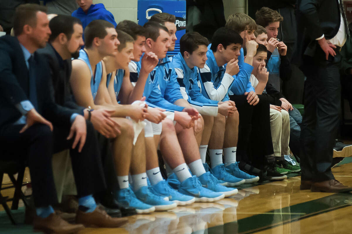 Meridian players watch from the bench as their team loses to Grand Rapids Covenant Christian in the Class C state quarterfinals on Tuesday, March 20, 2018 at Central Montcalm High School in Stanton. (Katy Kildee/kkildee@mdn.net)