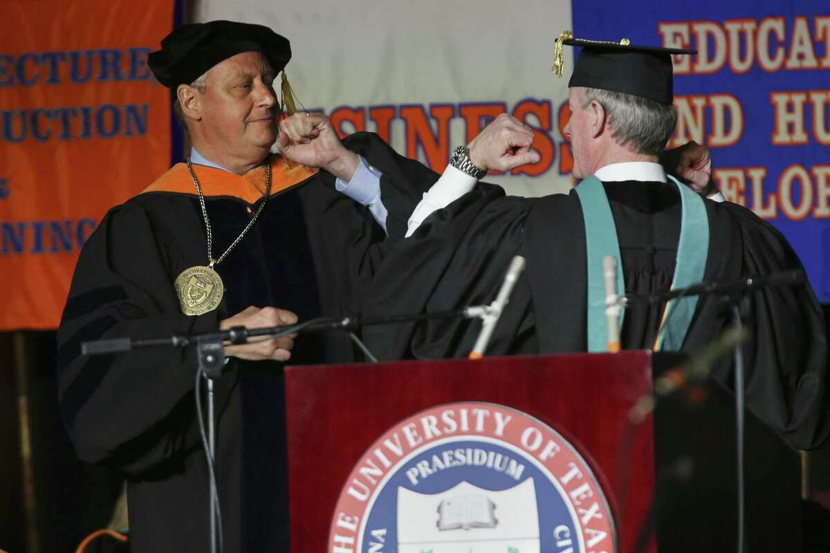 University of Texas at San Antonio President Taylor Eighmy, left, greets University of Texas System Chancellor William H. McRaven with “The Wing” greeting during Eighmy?’s inauguration ceremony at the Convocation Center, Tuesday, March 20, 2018.