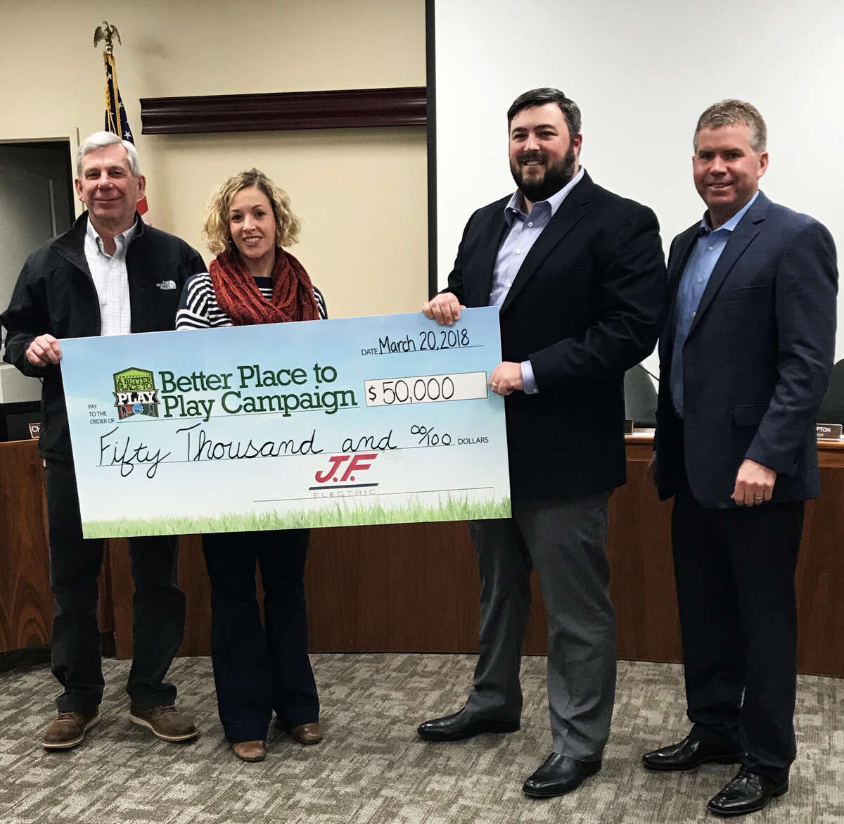 (From left) Director of Parks and Recreation Bob Pfeiffer, Assistant Director of Parks and Recreation Katie Grable, Jonathan Fowler and Edwardsville Mayor Hal Patton pose after receiving a donation from J.F. Electric to be contributed to the Plummer Family Sports Park.