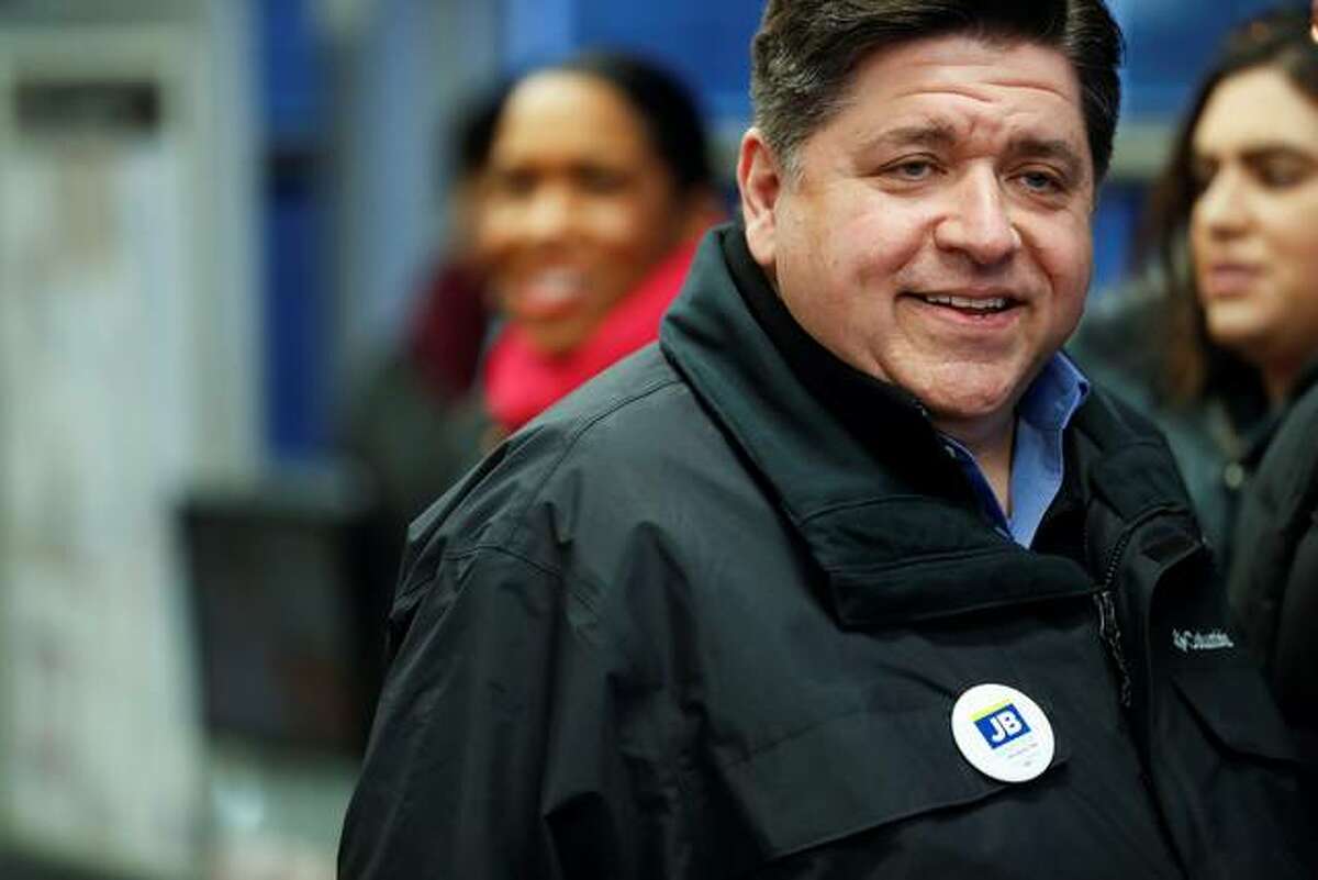 Illinois Democratic gubernatorial candidate J.B. Pritzker greets voters at the CTA Roosevelt Orange and Green Line station in Chicago on Election Day, Tuesday, March 20, 2018.