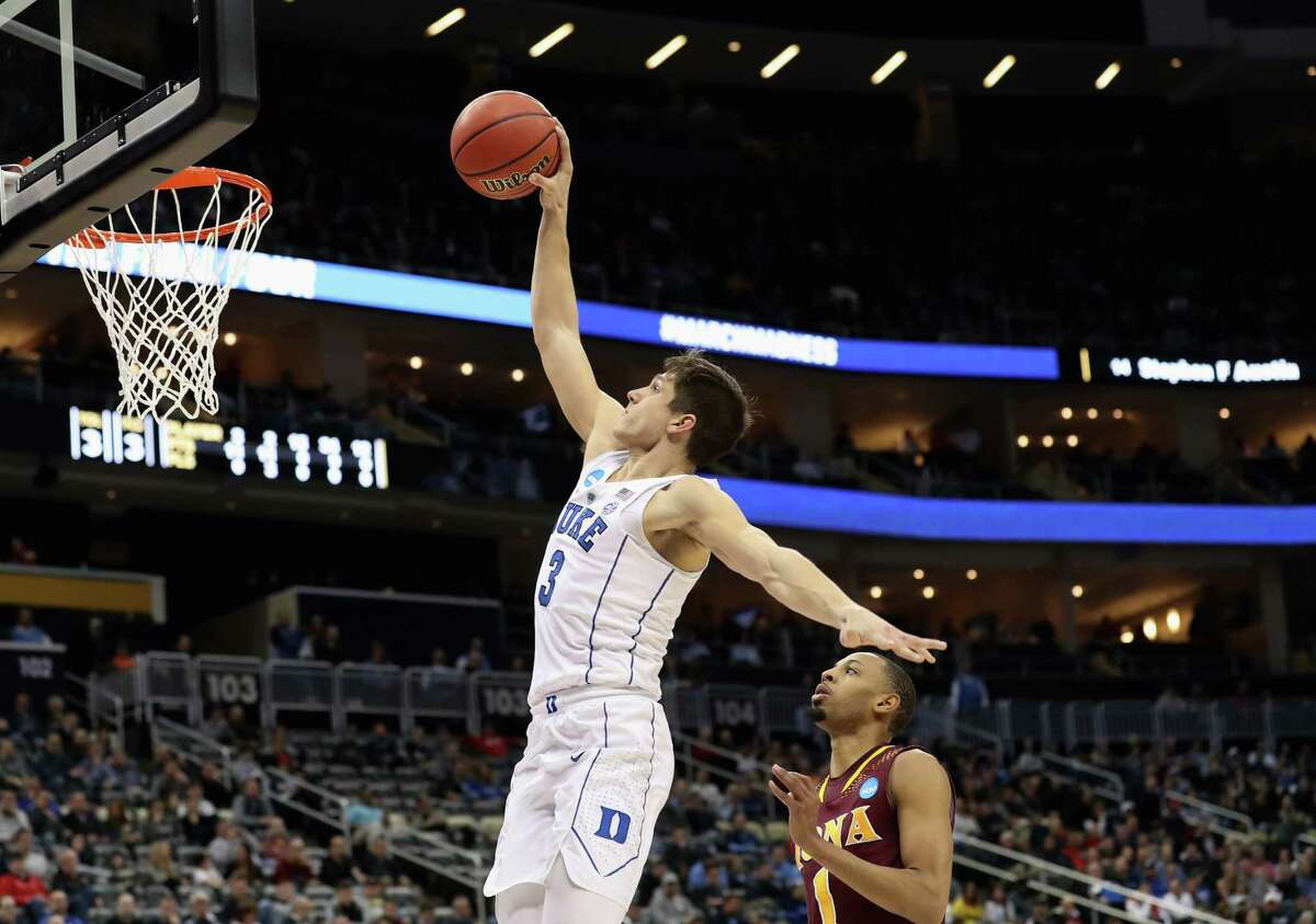 PITTSBURGH, PA - MARCH 15: Grayson Allen #3 of the Duke Blue Devils takes a shot ahead of Zach Lewis #1 of the Iona Gaels during the second half of the game in the first round of the 2018 NCAA Men's Basketball Tournament at PPG PAINTS Arena on March 15, 2018 in Pittsburgh, Pennsylvania. (Photo by Rob Carr/Getty Images)