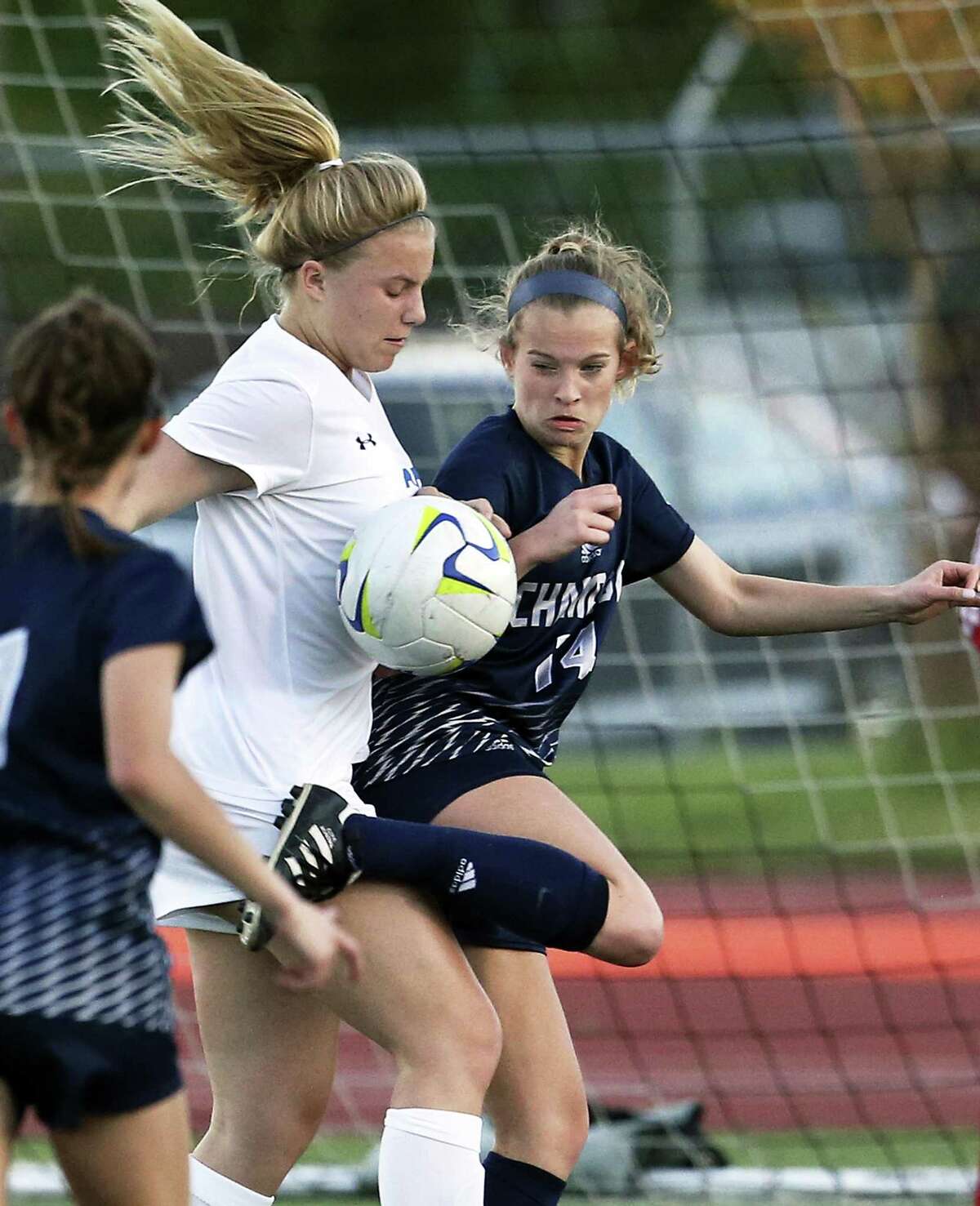 Champion's Mary Claire Stoelzing tries to heel the ball away from Abby Wagner defending against the visitor's threat on goal as the Alamo Heights hosts Champion in grils soccer at Orem Stadium on March 20, 2018.