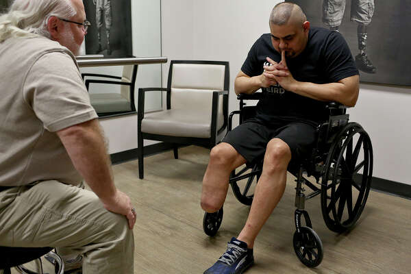 Isaac Rodriguez talks with prosthetist Randy Farley during his first consultation with Farley at Hanger Clinic in San Antonio on Tuesday, March 20, 2018.