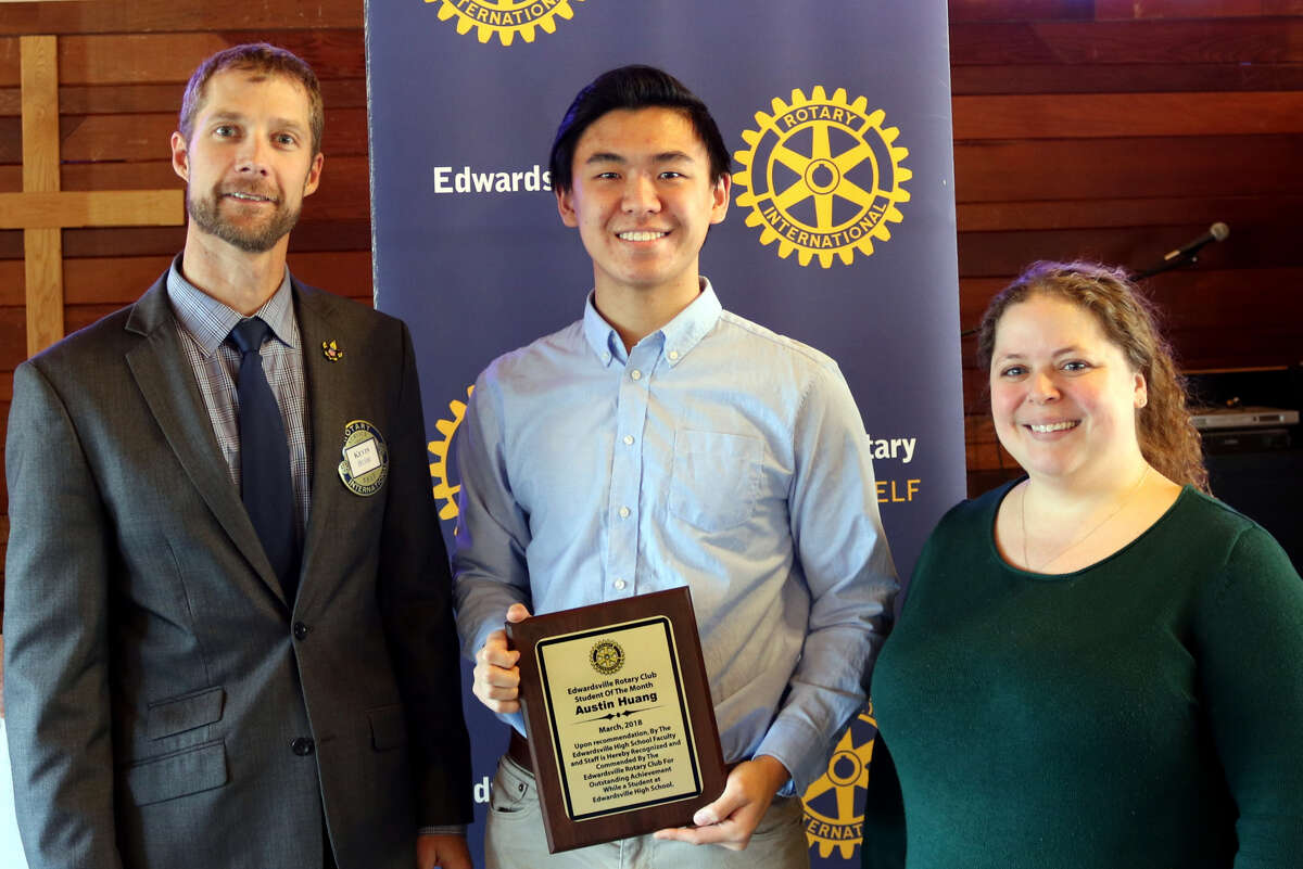 Austin Huang, center, receives the Edwardsville Rotary Club’s Student of the Month Award.
