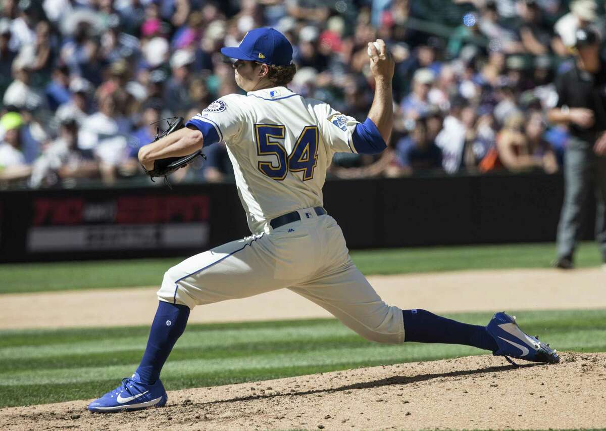 Reliever Emilio Pagan #54 of the Seattle Mariners delivers a pitch during an interleague game against the New York Mets at Safeco Field on July 30, 2017 in Seattle, Washington. The Mariners won the game 9-1.