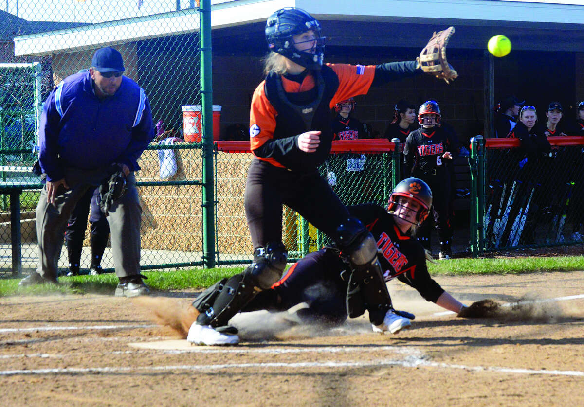 Edwardsville senior Anna Burke, bottom, slides in safely to home plate during the first inning against Gillespie on Wednesday inside the District 7 Sports Complex.