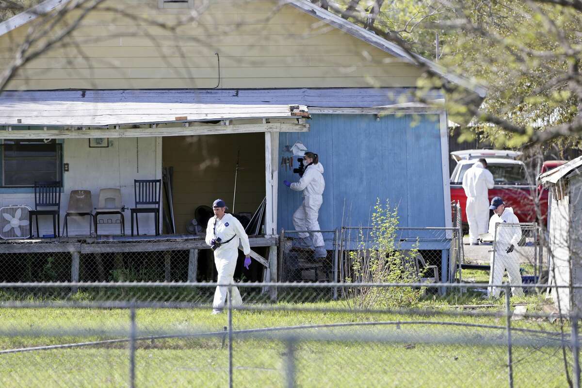 Crime scene photographers work through the backyard at the scene of Walnut and 2nd Street in Pflugerville where bombing suspect lived on March 21, 2018.