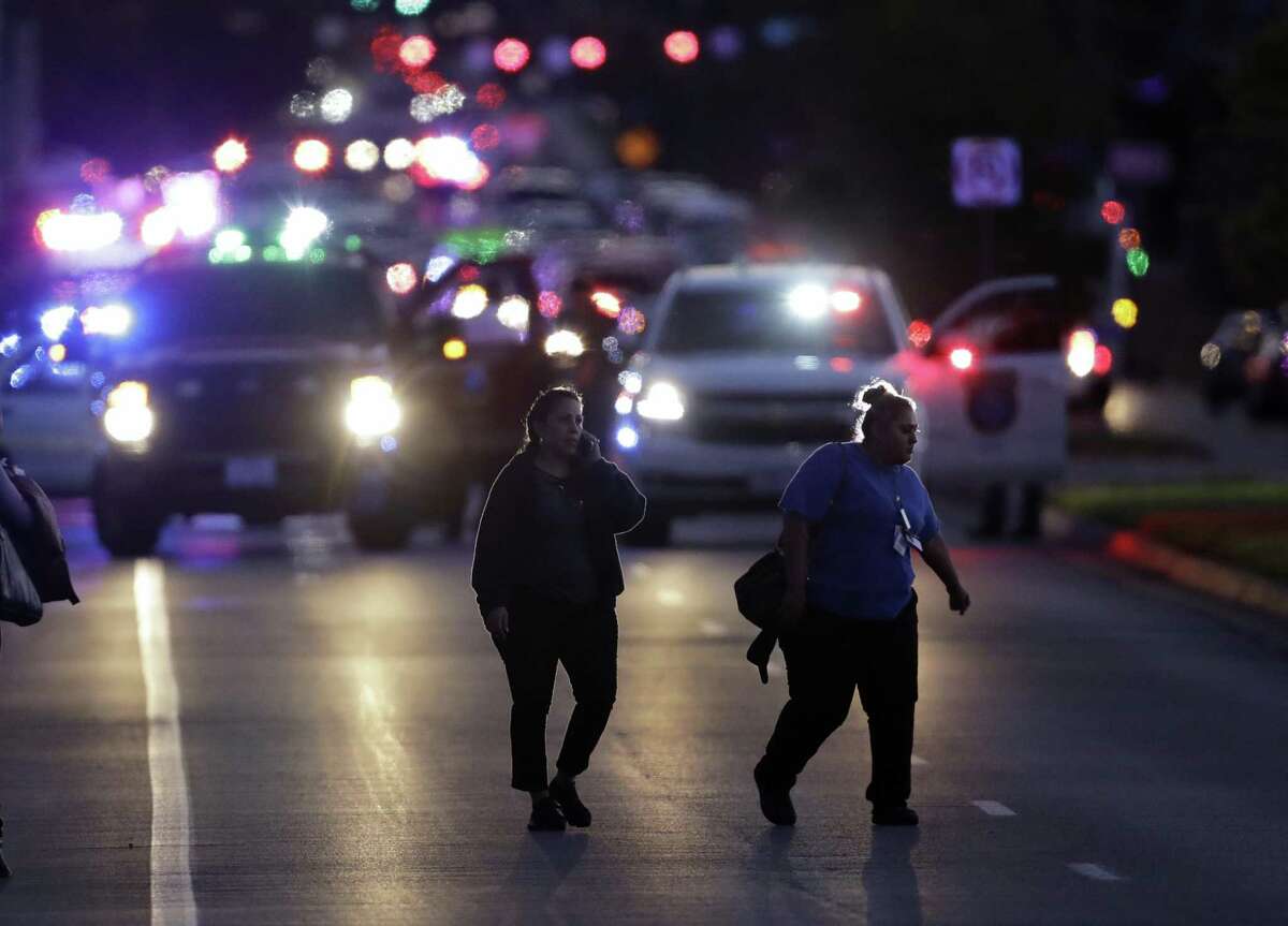 People evacuate as emergency vehicles stage near the site of another explosion, Tuesday, March 20, 2018, in Austin, Texas. (AP Photo/Eric Gay)