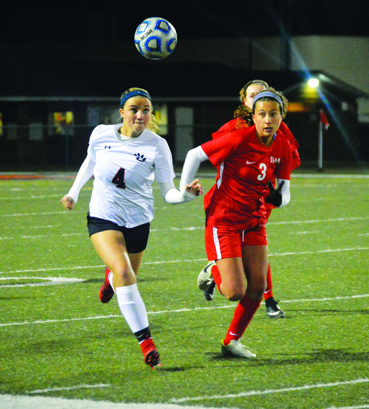 Edwardsville’s Emma Sitton, left, chases down a loose ball against Incarnate Word’s Maggie O’Brien in the second half.