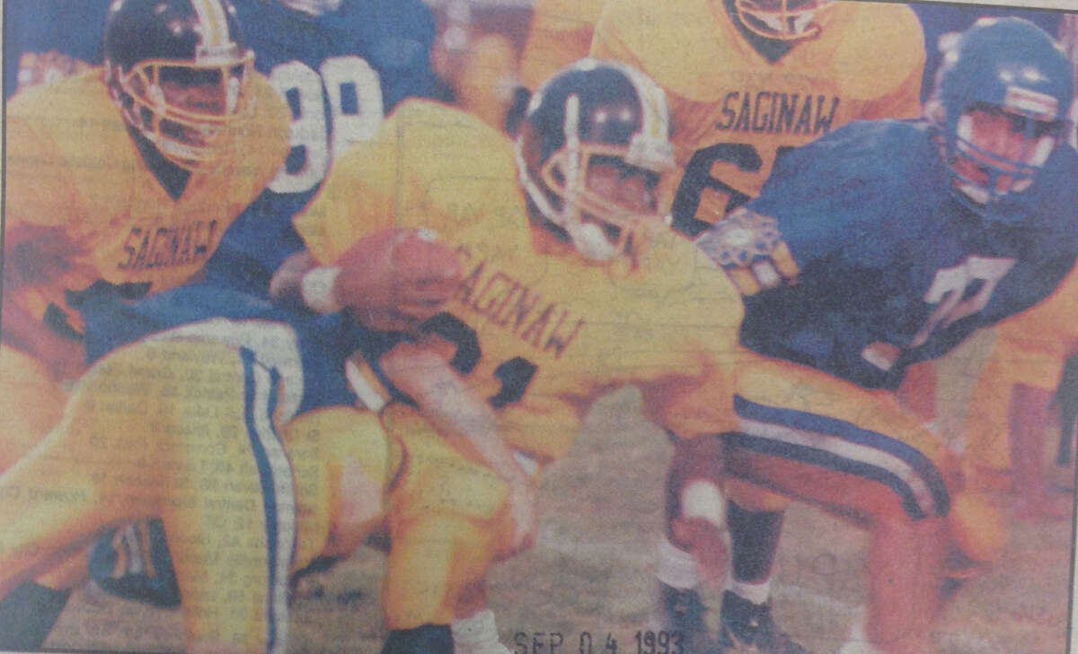 Saginaw High's Tony Martin (21) is tackled by an unidentified Midland High player during the season opener at Midland Stadium on Sept. 3, 1993. Coming to assist on the play are Midland's Jason Sedrowski (98) and Jakob Ostien (77). Midland won 24-7.
