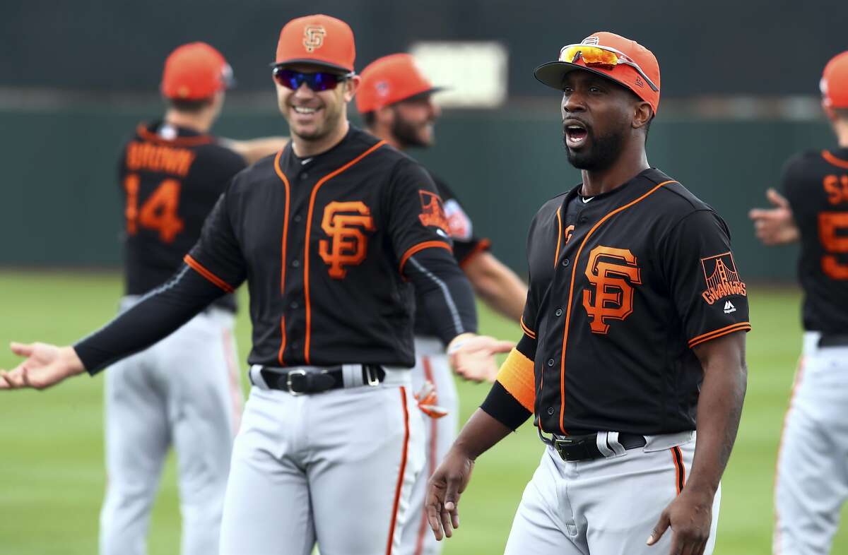 FILE - In this Feb. 19, 2018, file photo, San Francisco Giants' Andrew McCutchen, right, and Evan Longoria during a spring training baseball practice in Scottsdale, Ariz. Even the new faces of third baseman Longoria and McCutchen understand the pain of losing so many games and the importance of pushing past that to contend again after a 64-98 season. "I think they're going to be a huge key to our success this year," catcher Buster Posey said. (AP Photo/Ben Margot, File)