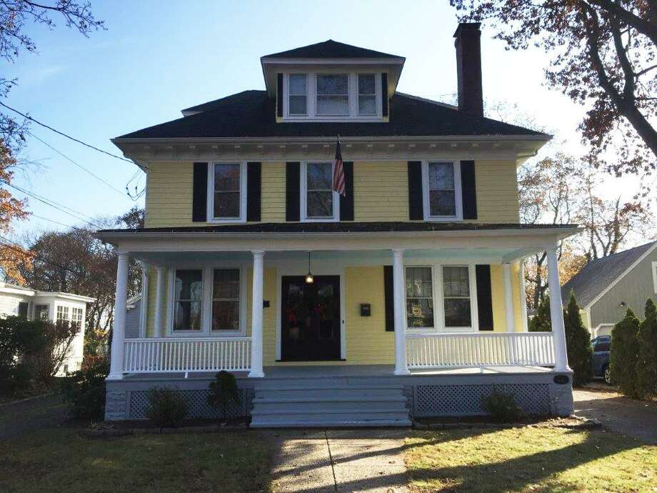 The classic Foursquare-style house at 27 Green St. in Milford was built in the early 20th century by Alfred Gould, of Milford's Harrison and Gould's Hardware store. The 2,938-square-foot, six-bedroom house reflects Gould's love of hardware and handicraft, with touches that include an iron spot brick fireplace, and red oak columns in many of the doorways. Photo: Contributed / Contributed