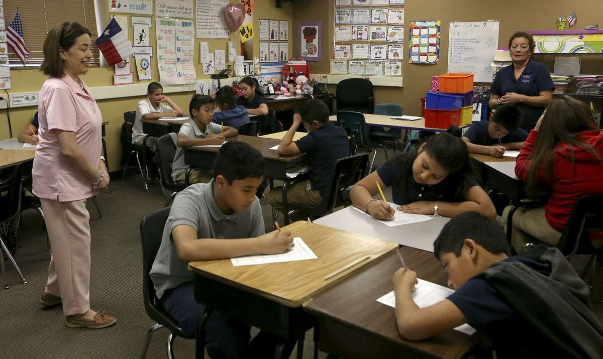 Fifth grade teacher Suzanne Zuniga (left) teaches class after the announcement of the Early College High School Partnership between Southwest Preparatory's Northwest Campus and Texas A&M-San Antonio. The new ECHS will allow students to earn up to 60 credit hours toward a four-year degree by taking classes at the TAMUSA campus.
