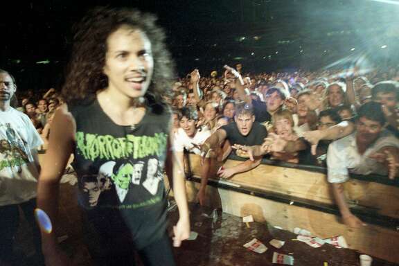 Oct. 12, 1991: Kirk Hammett greets the crowd before Metallica's rowdy Day on the Green performance at the Oakland Coliseum in 1991.