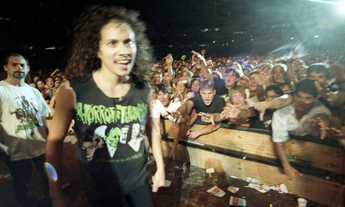 Kirk Hammett greets the crowd before Metallica's rowdy Day on the Green performance at the Oakland Coliseum in 1991.