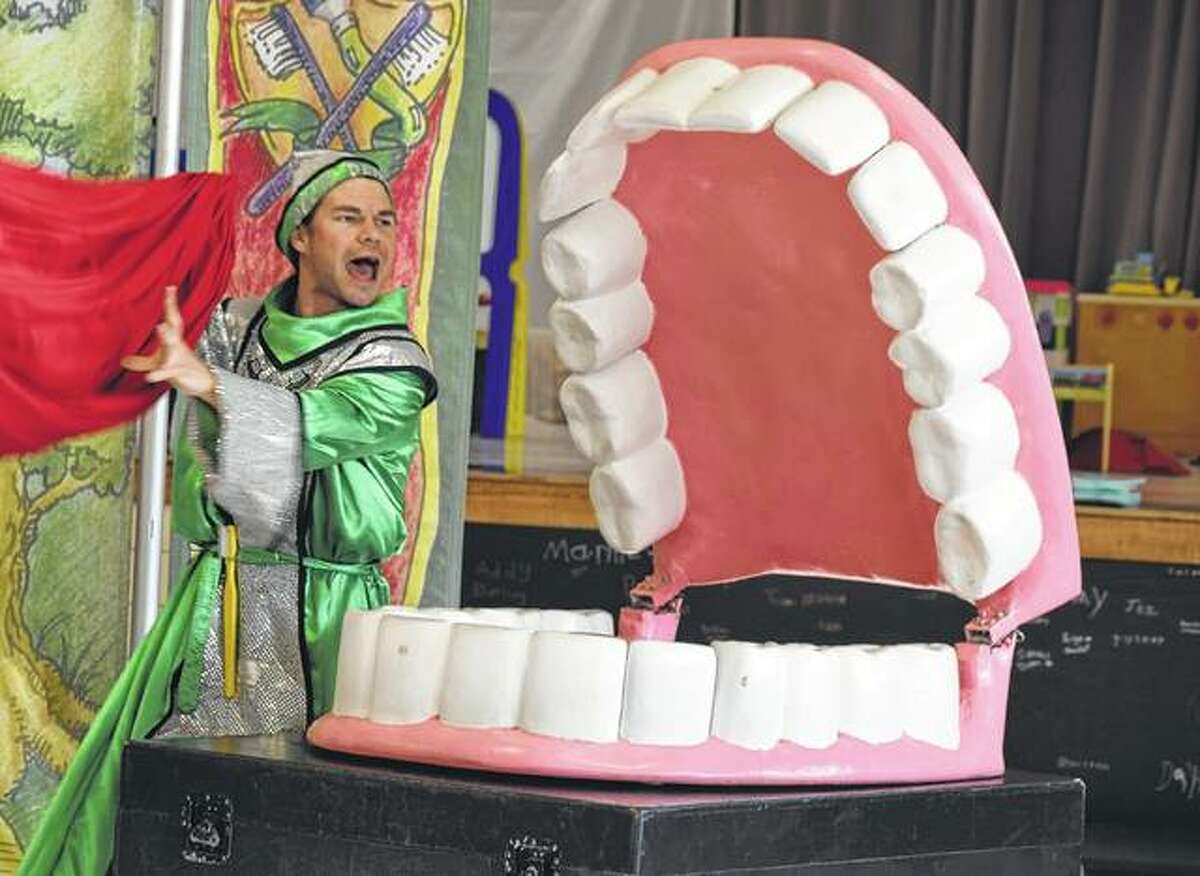 The Tooth Wizard from Delta Dental reveals his giant mouth Thursday during a program at Murrayville-Woodson Elementary School.