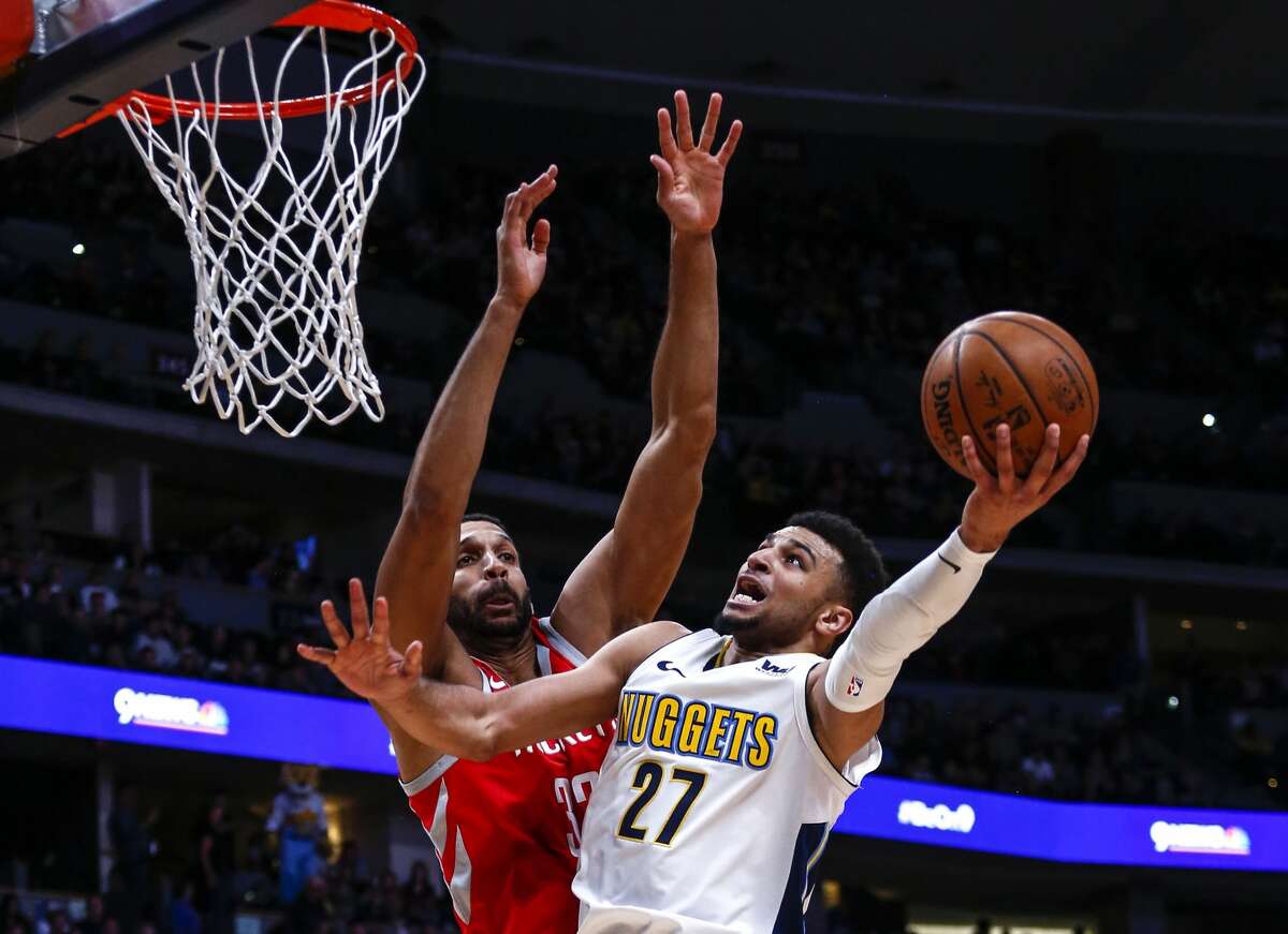 Denver Nuggets guard Jamal Murray (27) goes up for a shot against Houston Rockets forward Brandan Wright (32) during the third quarter of an NBA basketball game, Sunday, Feb. 25, 2018, in Denver. (AP Photo/Jack Dempsey)