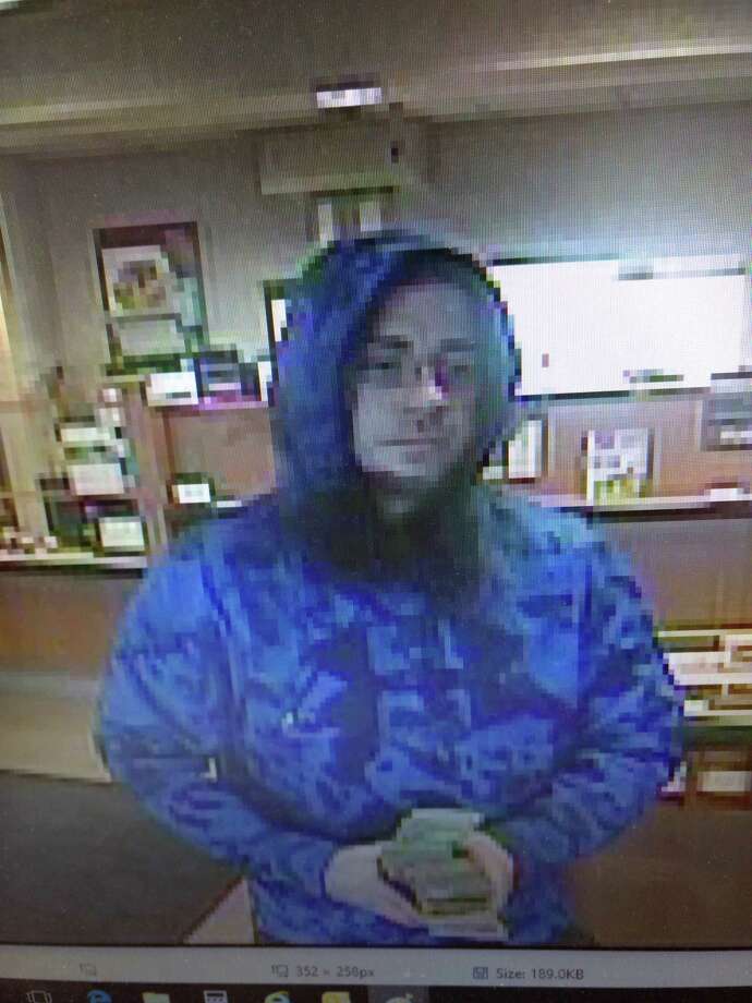 Colonie police are searching for information about the individual pictured in these images captured by video surveillance cameras during a robbery at the NBT Bank on Troy-Schenectady Road in the town of Colonie on Friday, March 23, 2018. Photo: Colonie Police