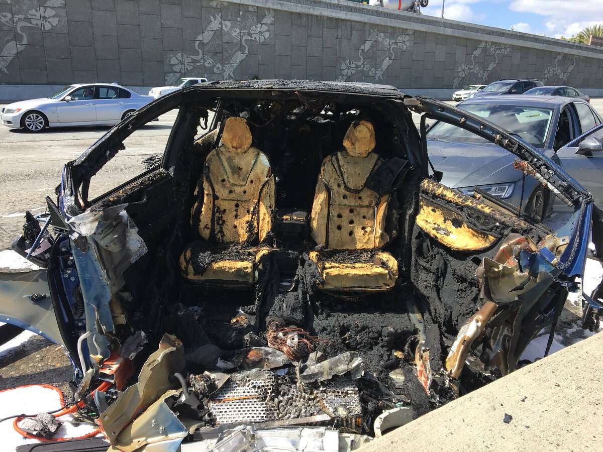 The blue Tesla was driving southbound on Highway 101 at freeway speeds near Highway 85, the CHP said, when it collided with a barrier separating the carpool lanes on both roads and caught fire.