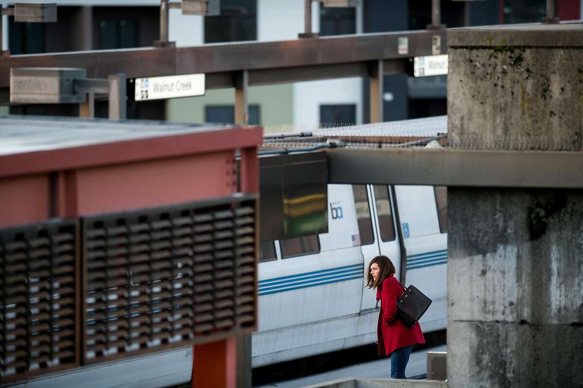 A commuter waits for a train at the Walnut Creek BART station on Friday, March 23, 2018, in Walnut Creek, Calif.
