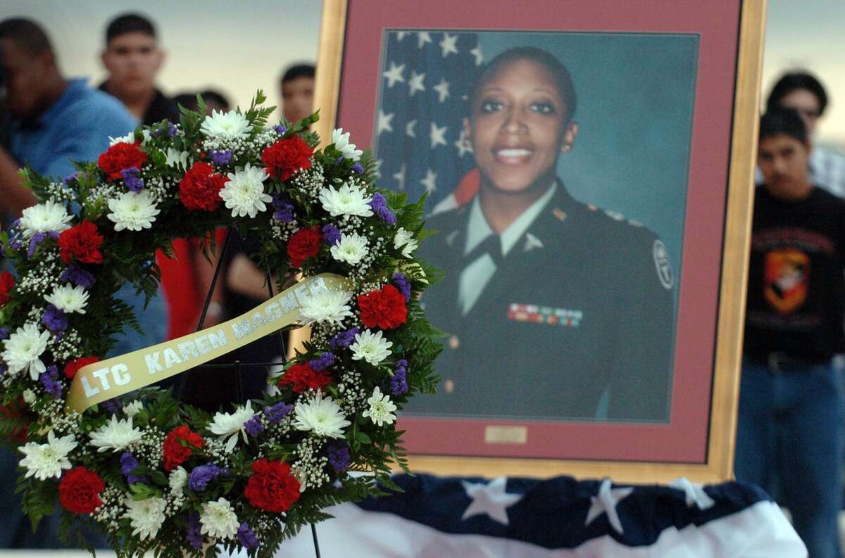 A portrait of the late Lt. Col. Karen Wagner stands next to a wreath as students from Wagner High School gather in front of the school on Sept. 11, 2006, to honor her memory. The school was named in her honor after she died at the Pentagon Sept. 11, 2001.