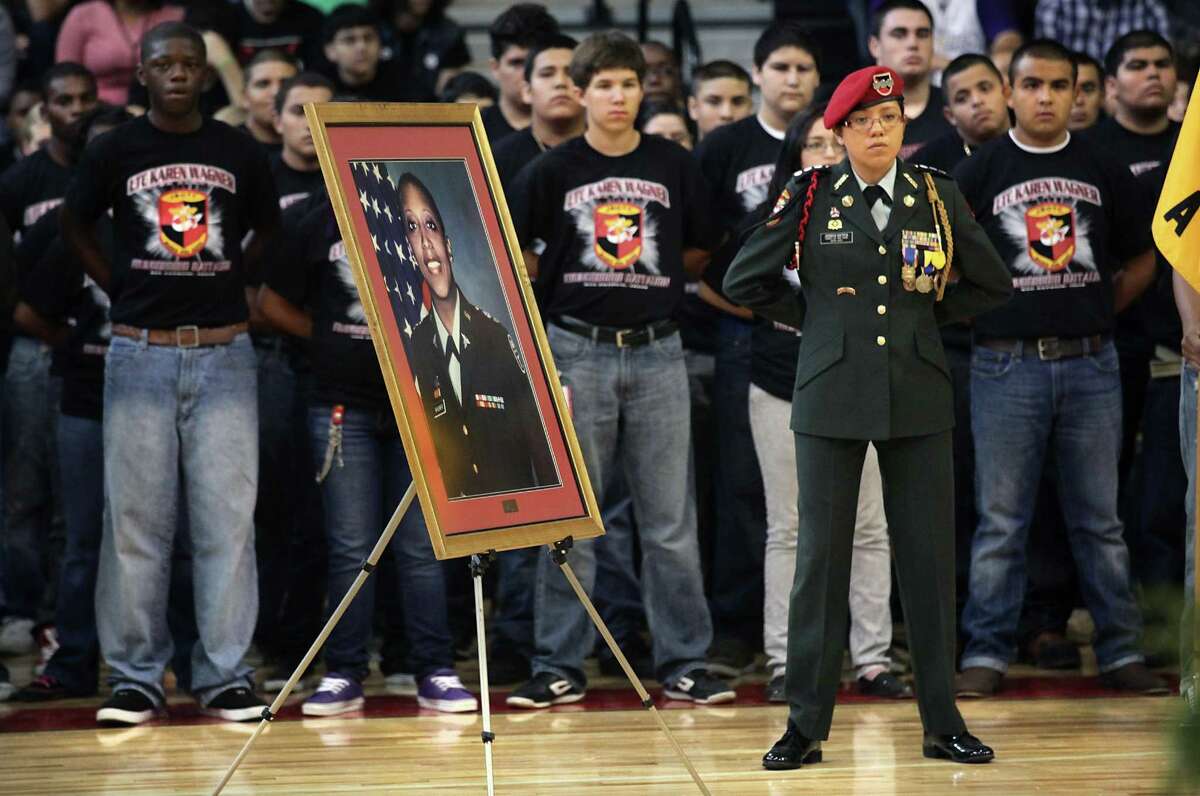 Cadet Captain Jessica Gatica (right) stands next to a portrait of Lt, Col. Karen Wagner with other members of the Karen Wagner High School Jr. ROTC as they take part in the school's ceremony honoring the life of Wagner, who was killed on 9/11 at the Pentagon, in observance of the 10th anniversary of 9/11.